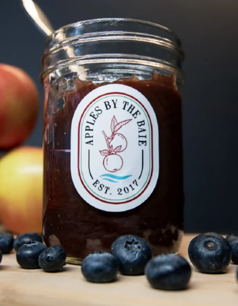 Jar of apple blueberry jam with fresh blueberries